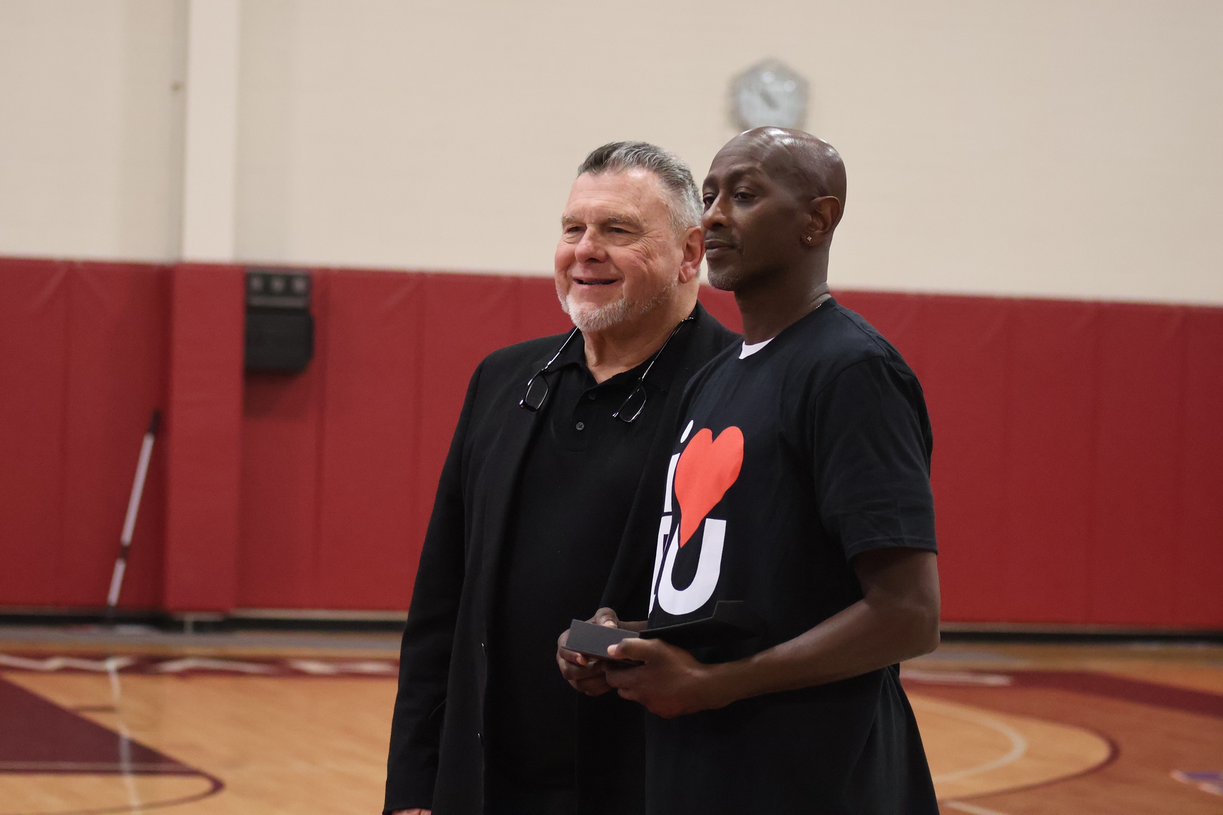 Sayles pictured alongside Athletic Director Emeritus Garth Pleasant